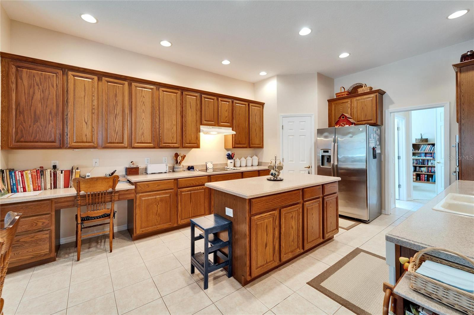 Kitchen with a built in desk, and island .