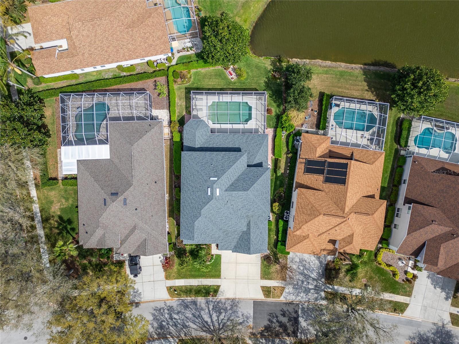 Home with the gray roof is yours.  The park bench overlooking the pond is a true gem.