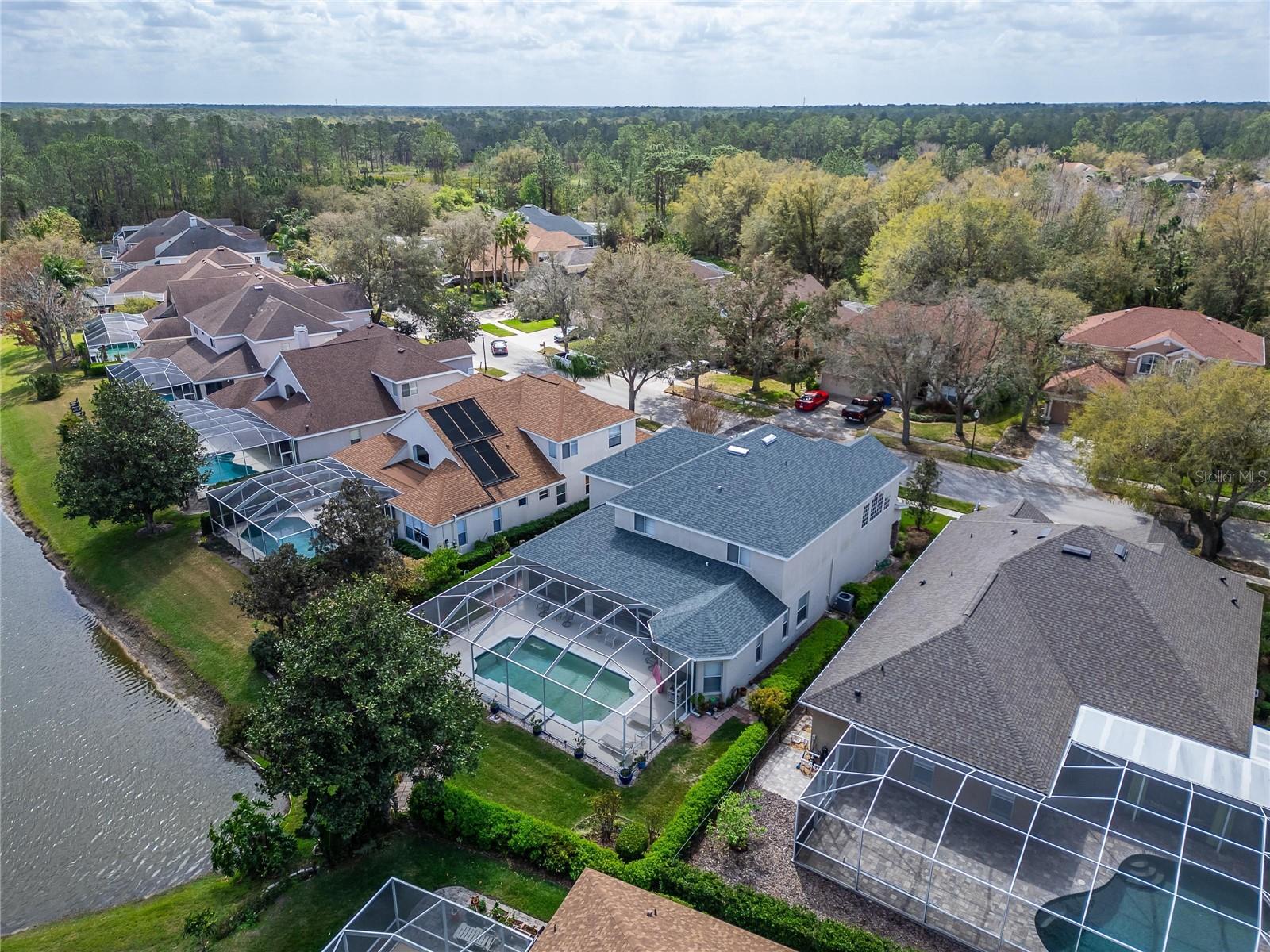 Home with the gray roof is yours.  Large screened enclosure with heated pool.