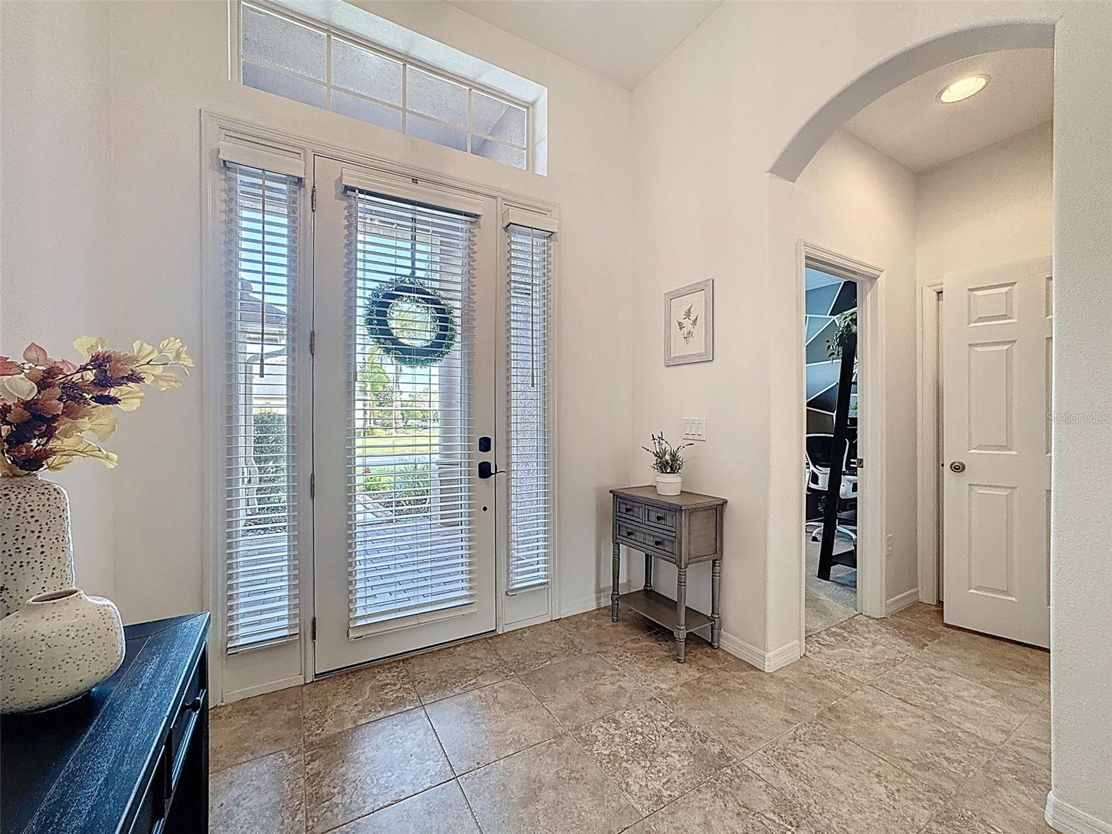 ELEGANT ENTRYWAY WITH GLASS DOOR AND DOUBLE GLASS SIDELIGHTS TO LET THE SUN SHINE IN!