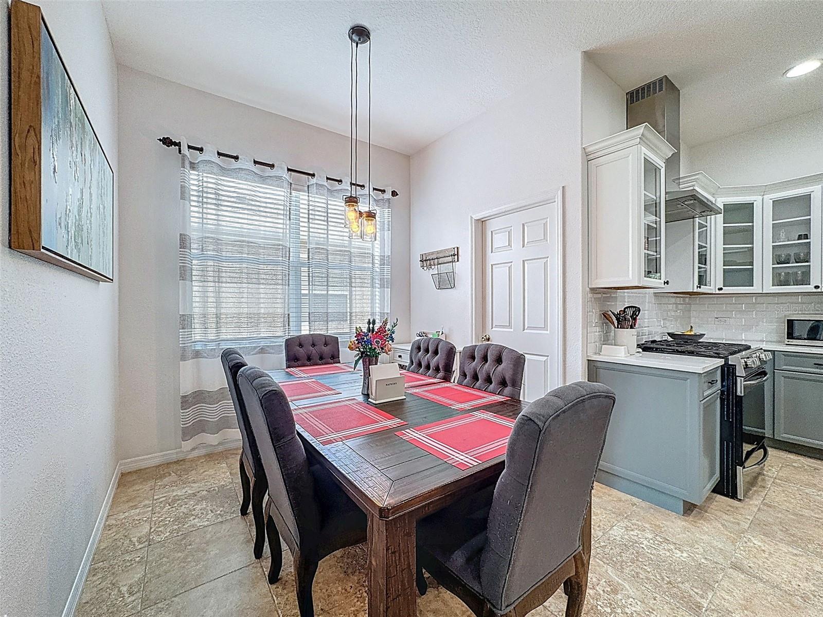 LARGER KITCHEN NOOK AREA WITH ACCESS TO THE UTILITY ROOM TO THE GARAGE