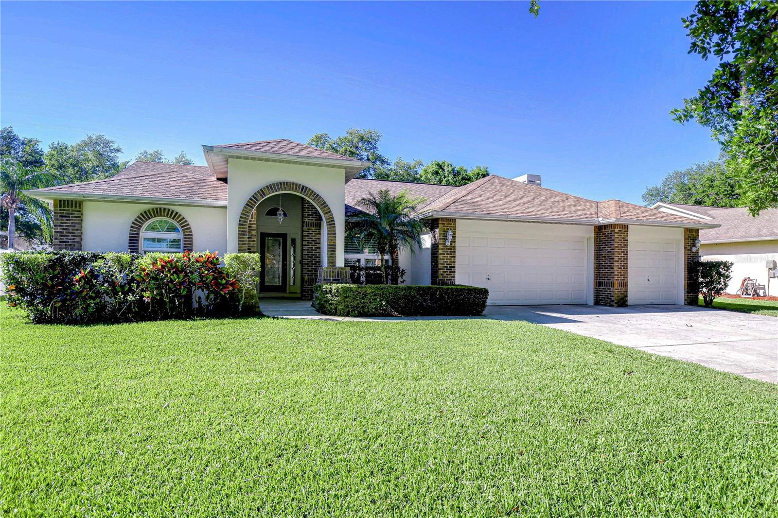 Step into this charming gem with irresistible curb appeal, boasting a lush, manicured lawn and inviting arched entryway