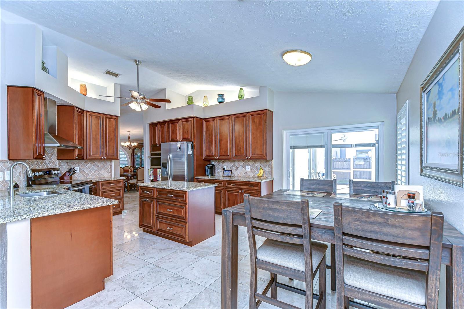 Expansive granite countertops and a cozy breakfast nook invite you to savor every moment.