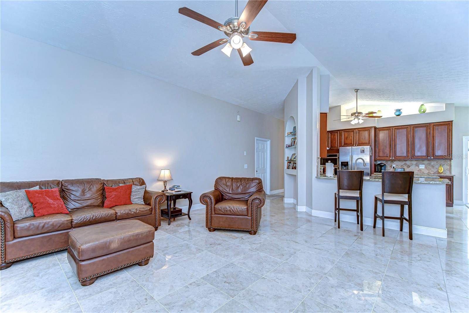 . The open concept flows seamlessly into a stylish kitchen, perfect for entertaining or a quiet night in.