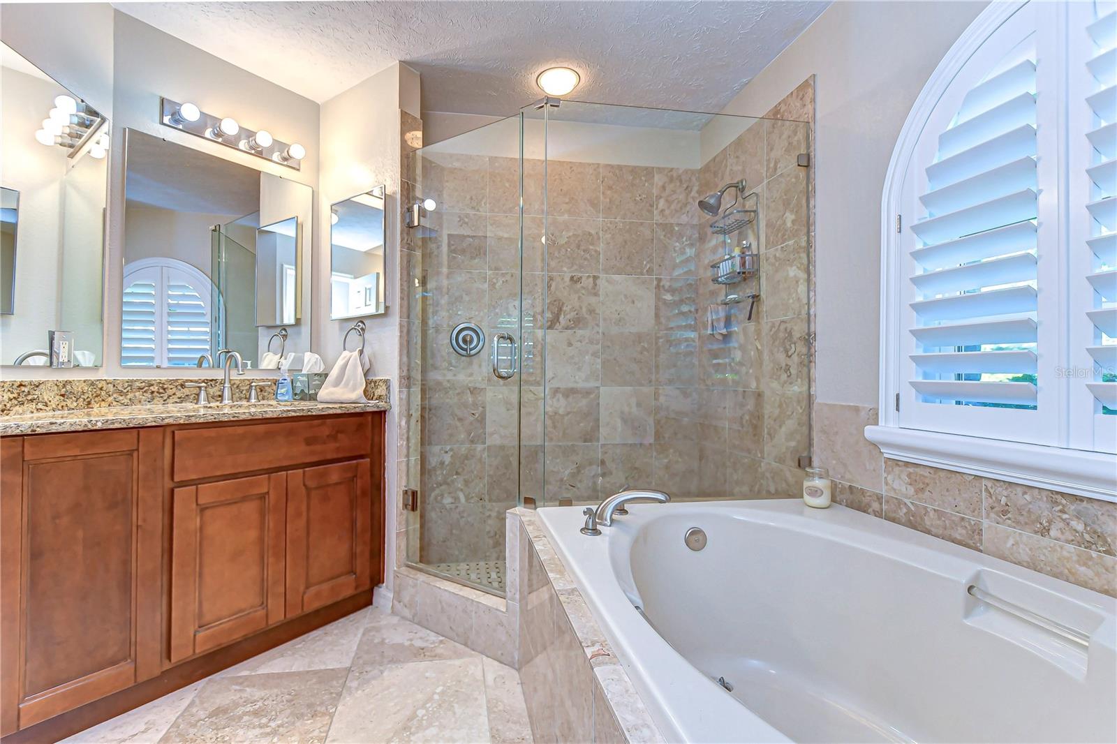 Dual vanities with granite countertops provide ample space