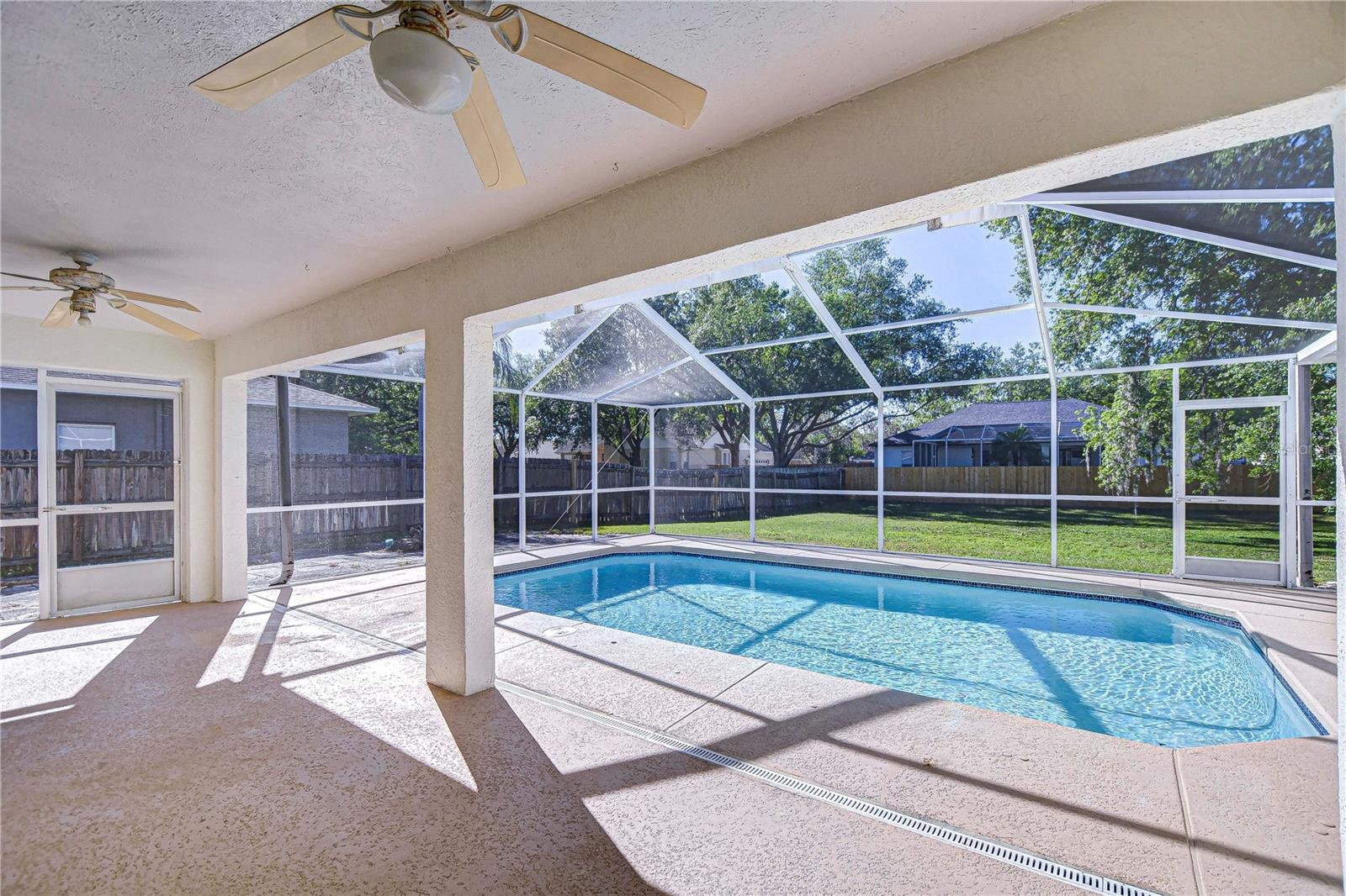 Discover your personal oasis with this inviting screened-in pool area, perfect for year-round enjoyment without the worry of pesky insects.