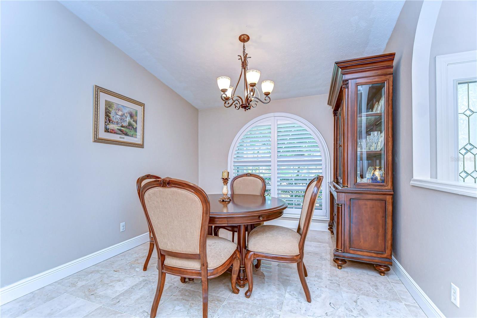 Step into elegance with this delightful dining nook, where intimate gatherings meet timeless charm.