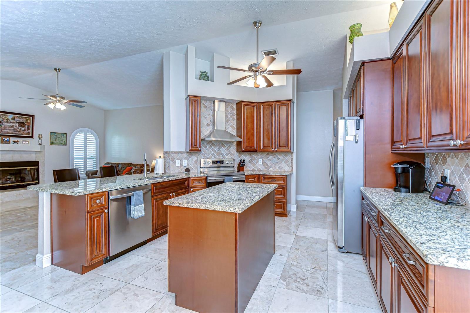 Discover the heart of this home—a stunning kitchen boasting elegant granite countertops and rich wooden cabinetry that adds a touch of sophistication.