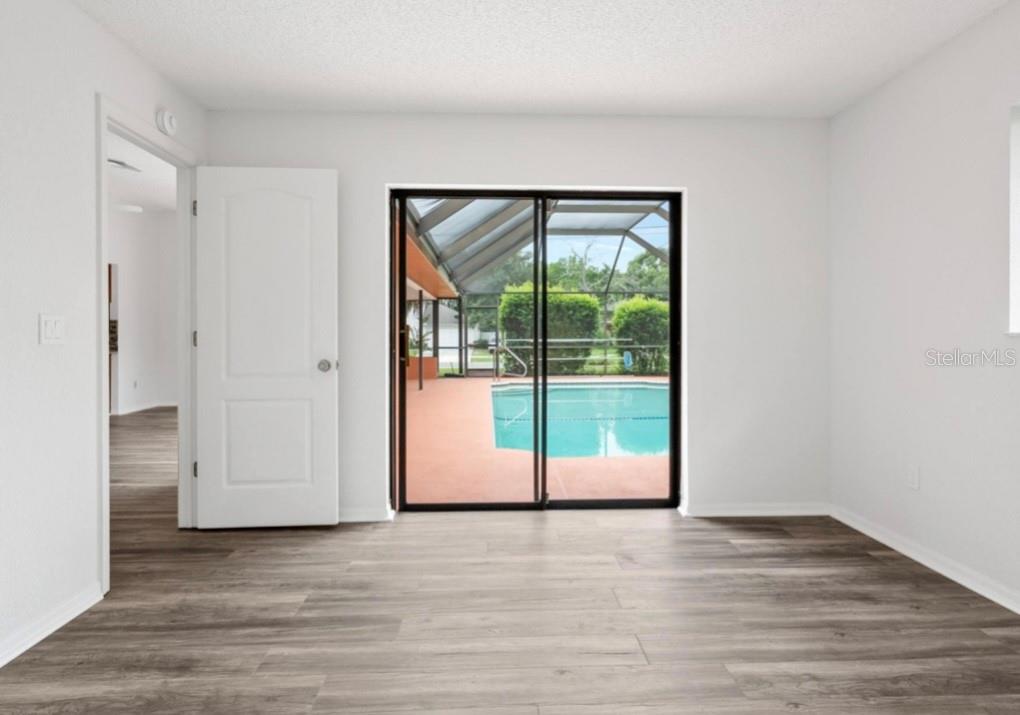 Guest Bedroom one has sliding glass doors outn to nthe pool