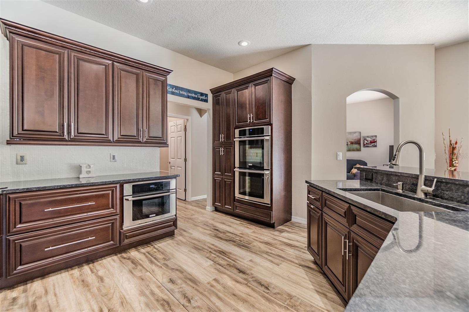 New Backsplash, Gas Range and Hood, Double Oven, Microwave and dishwasher, Granite counter tops.