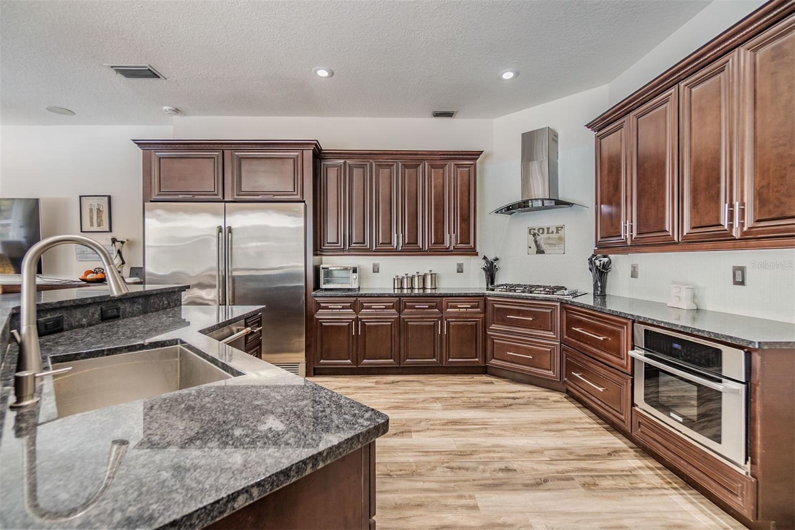 New Backsplash, Gas Range and Hood, Double Oven, Microwave and dishwasher, Granite counter tops.