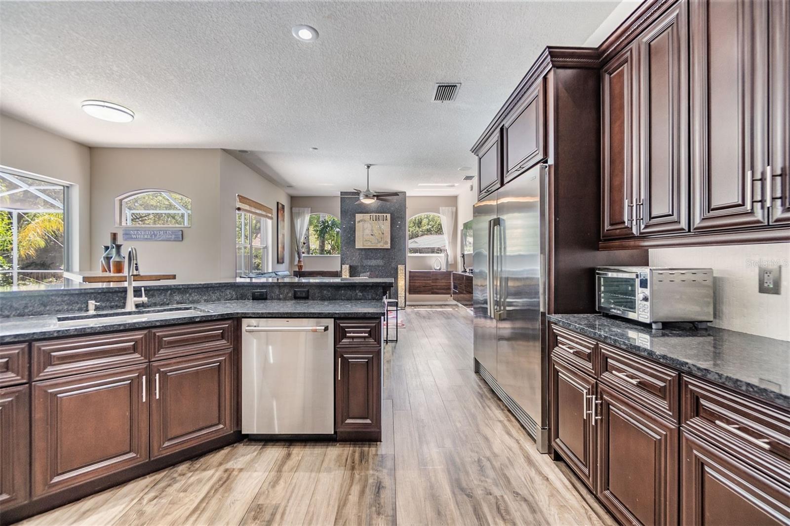 New Backsplash, Gas Range and Hood, Double Oven, Microwave and dishwasher, Granite counter tops.