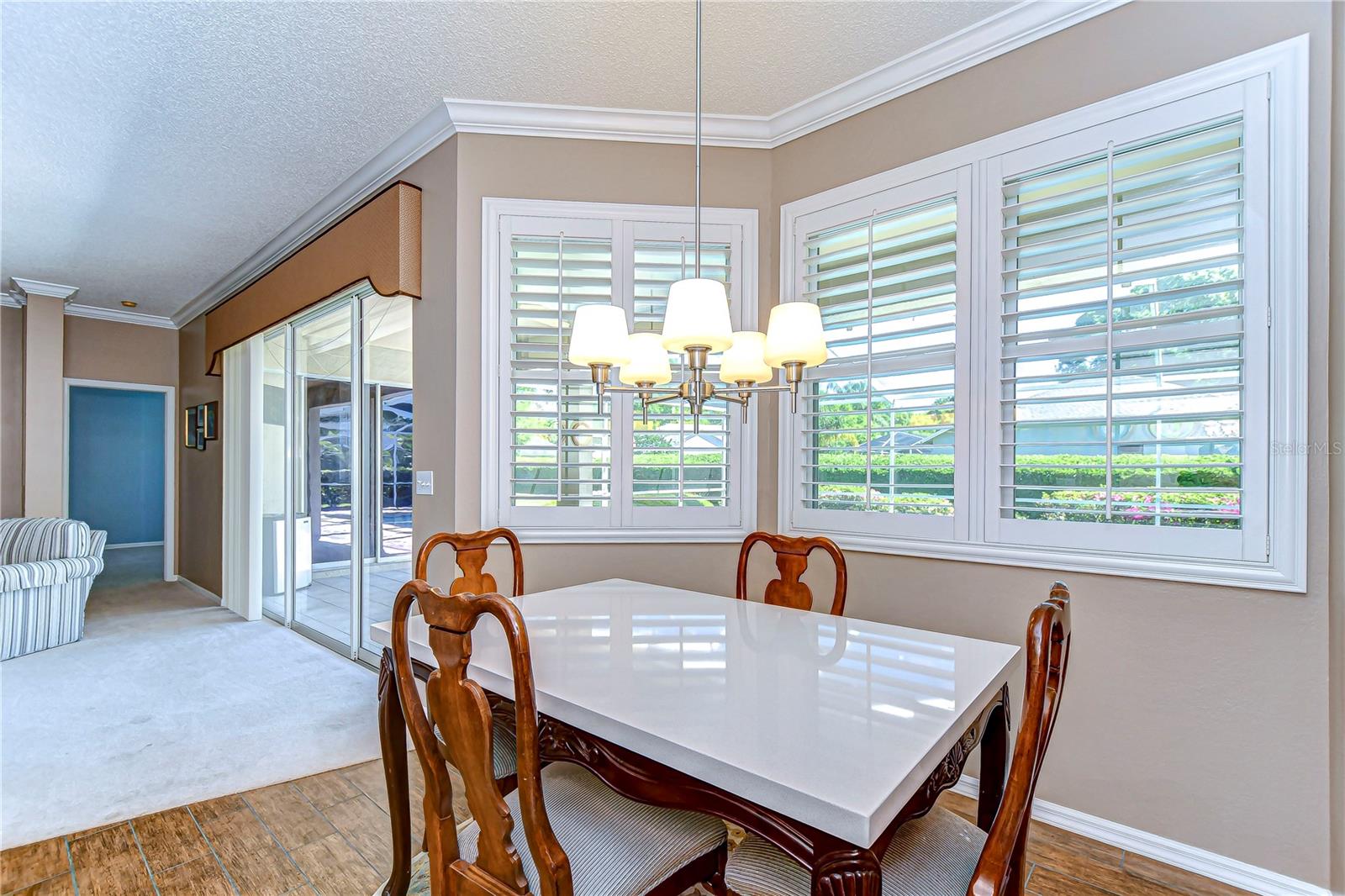 Bathed in natural light through the elegant plantation shutters, this dining area promises the perfect setting for both intimate dinners and lively brunches.