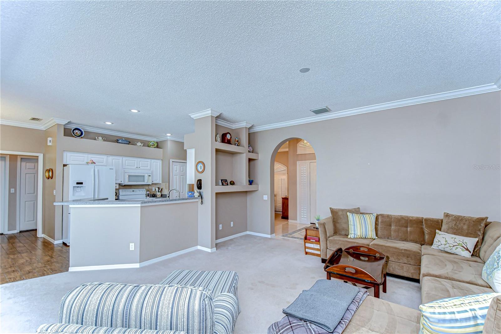 The living room seamlessly merges with a bright, open kitchen—perfect for cooking up culinary delights while entertaining guests.