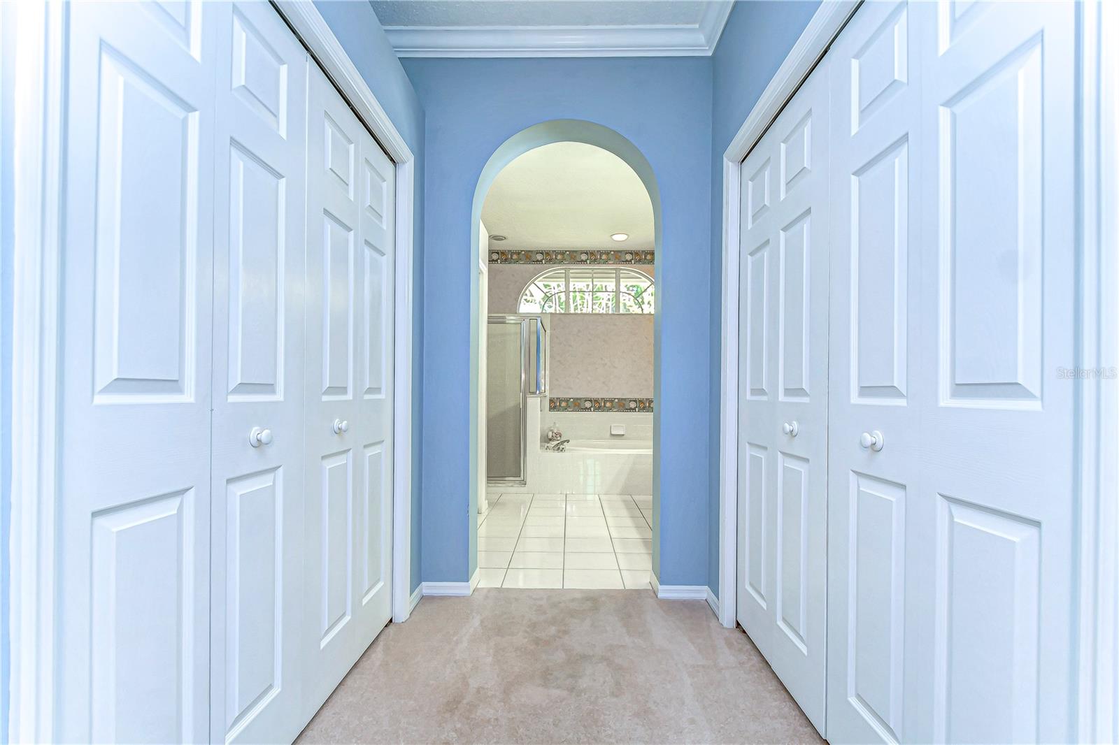 Flanked by double closets, this serene hallway offers both elegance and ample storage.