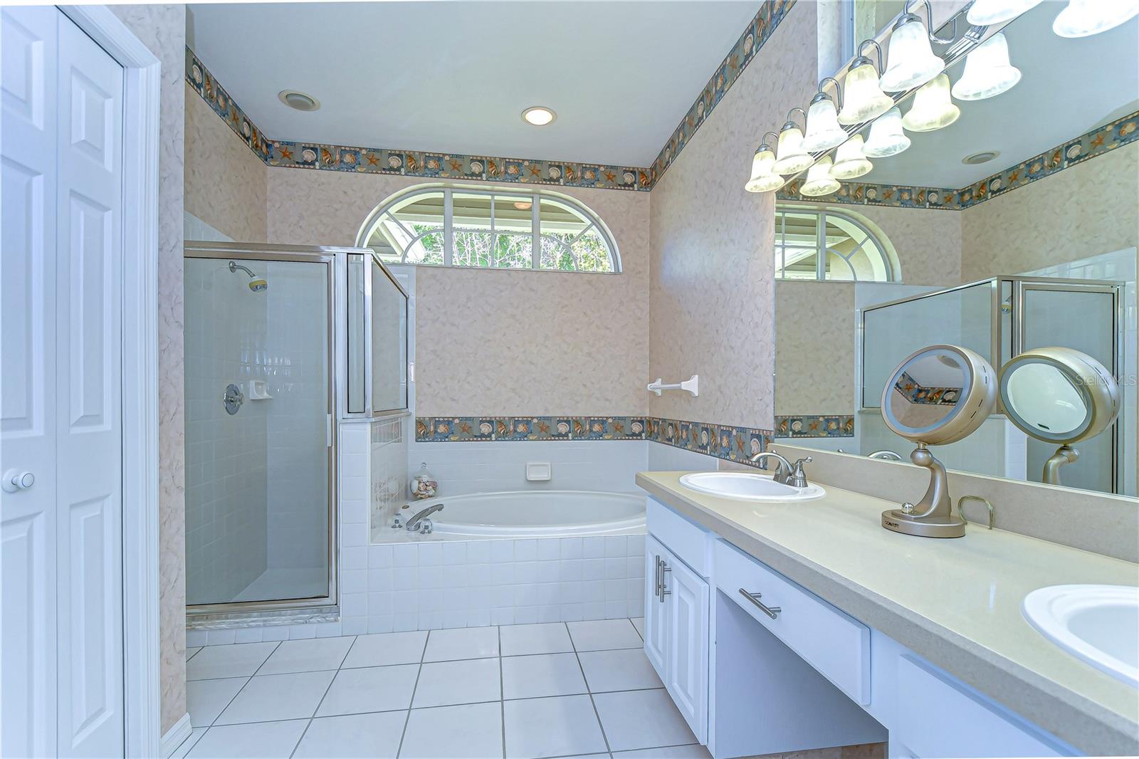 This charming bathroom provides a delightful blend of functionality and style, offering a tranquil retreat with its dual sinks and spacious countertop.