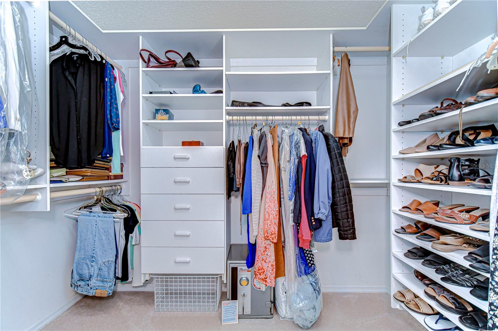 Step into an organizer's dream with this spacious walk-in closet, designed to keep your wardrobe in pristine order.