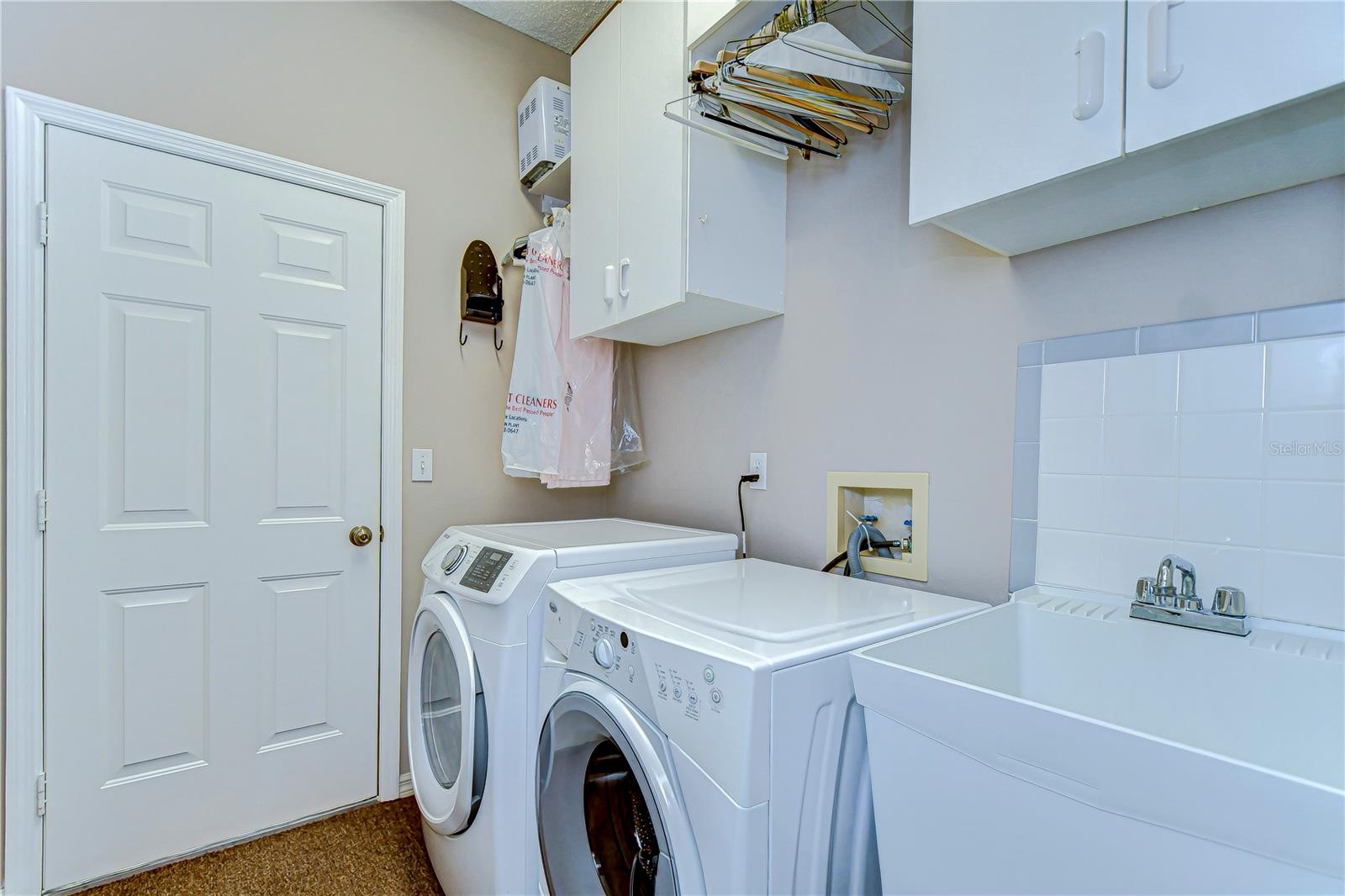 Welcome to your new laundry haven, where chores become a breeze in this meticulously organized space.