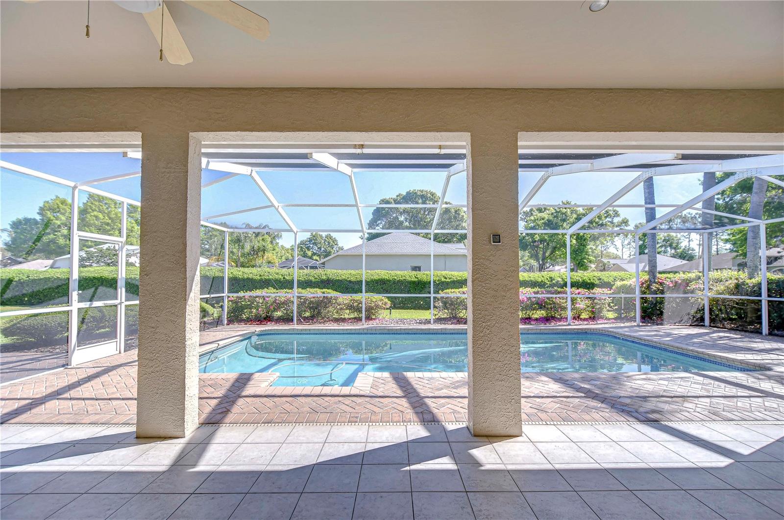 Step into your own personal oasis with this stunning screen-enclosed pool area, offering the perfect blend of privacy and panoramic views of the lush greenery beyond.