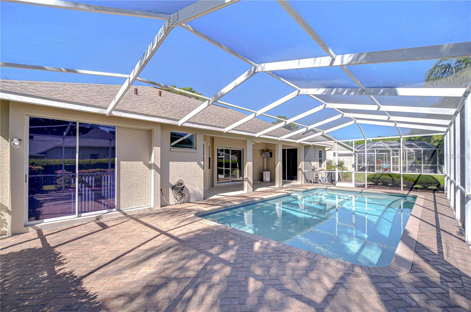 Step into your personal oasis with this enchanting screened-in pool area, perfect for both sun-soaked relaxation and twilight gatherings.