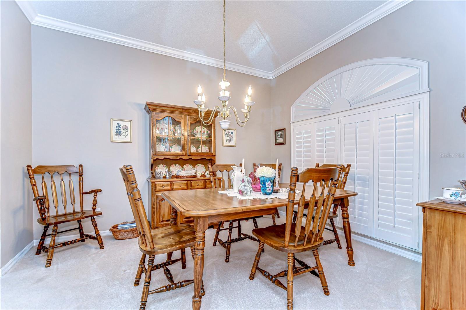 Step into this classic dining area where charm and comfort unite to create a delightful space for both everyday meals and festive gatherings.