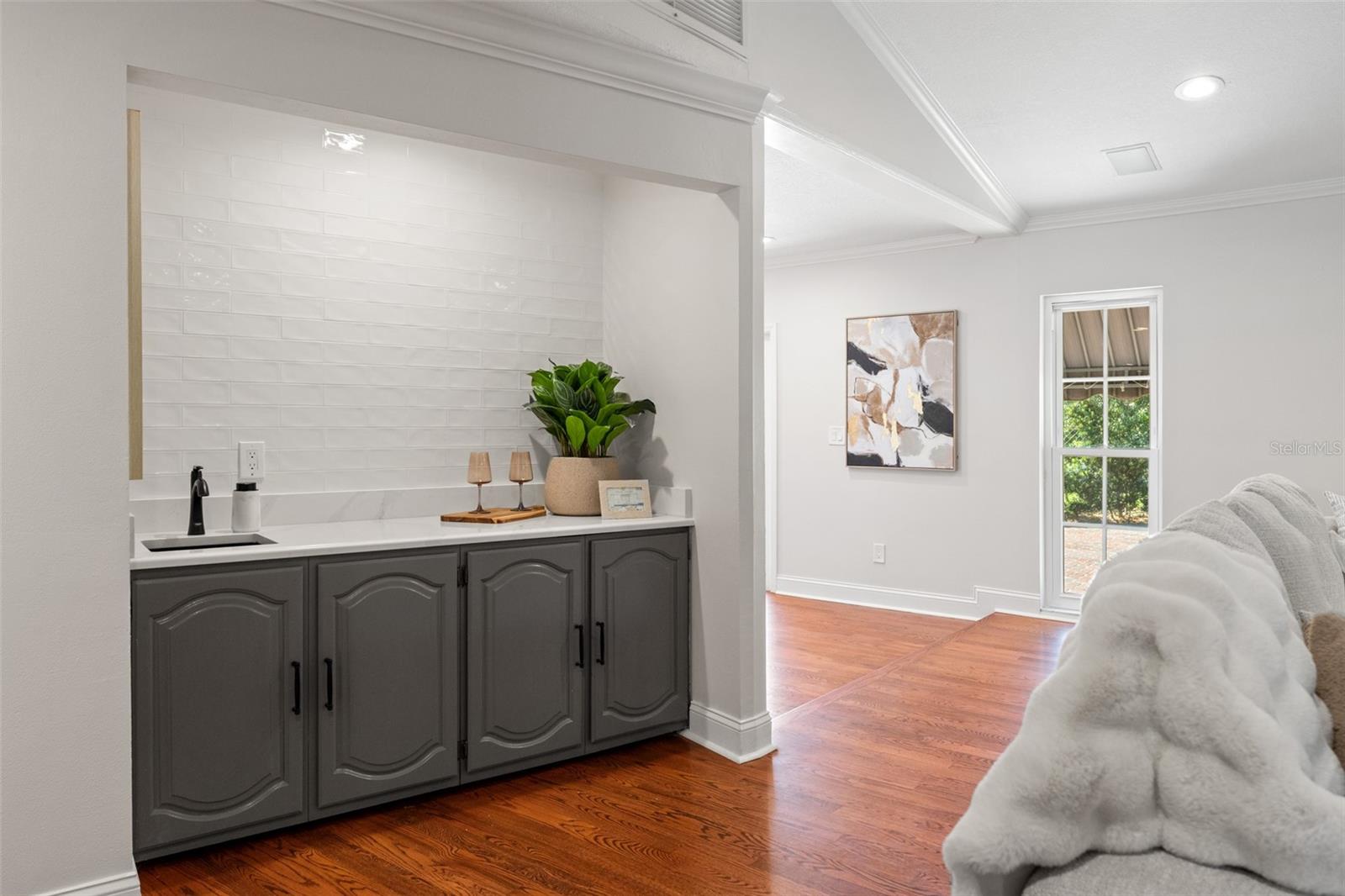 New Wet Bar, Finished in Hand-Crafted Glazed Tile and Gold Calcutta Quartz Counters with Matte-Black Metal Work.