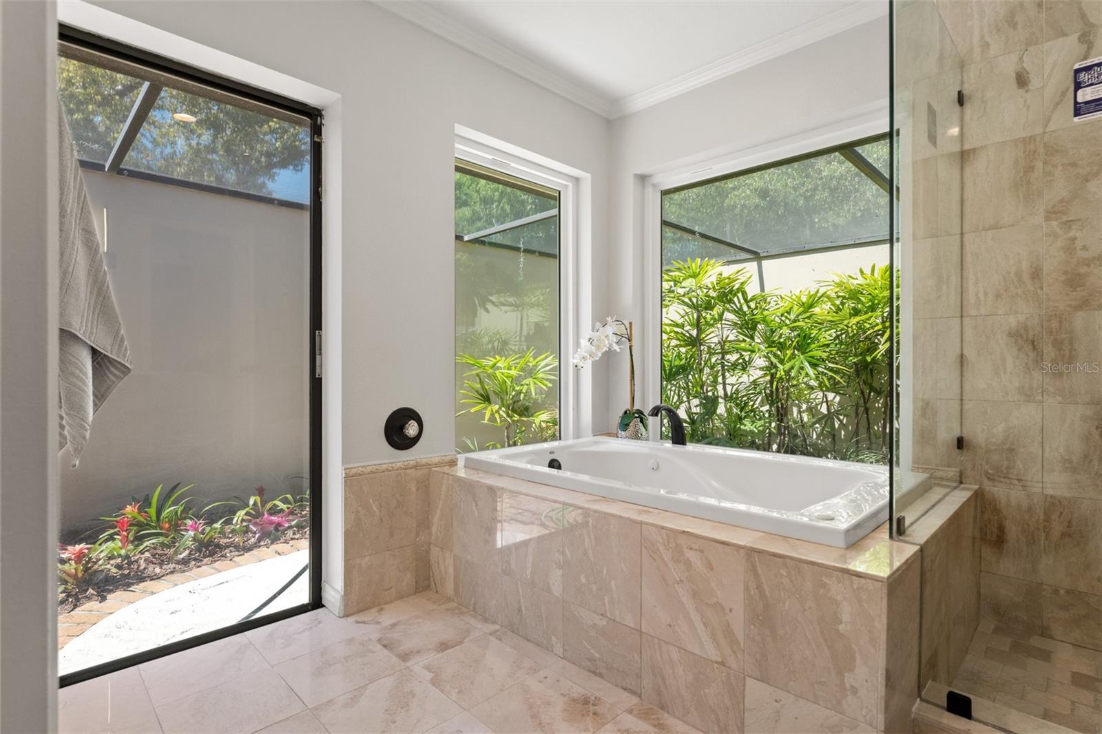 Primary Bath Opens To A Private Walled Terrace and Garden, With Pavered Path Leading To Pool and Gardens.