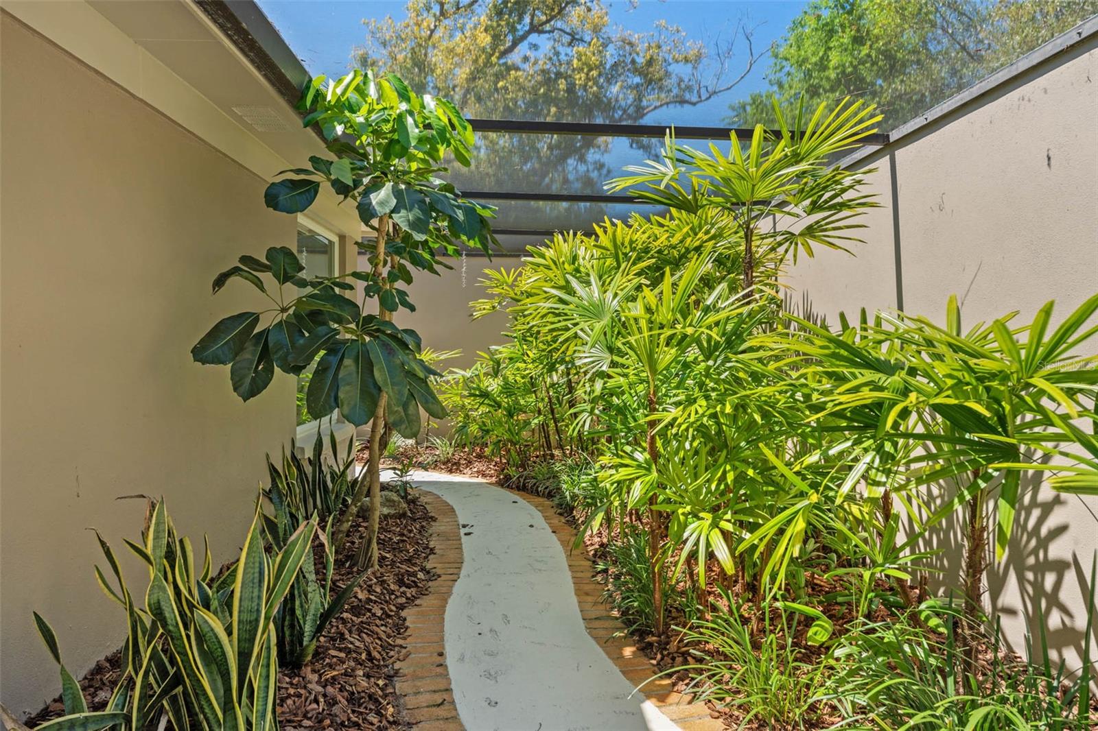 Curving Pavered Pathway from Private Primary Bath to Pool and Gardens.