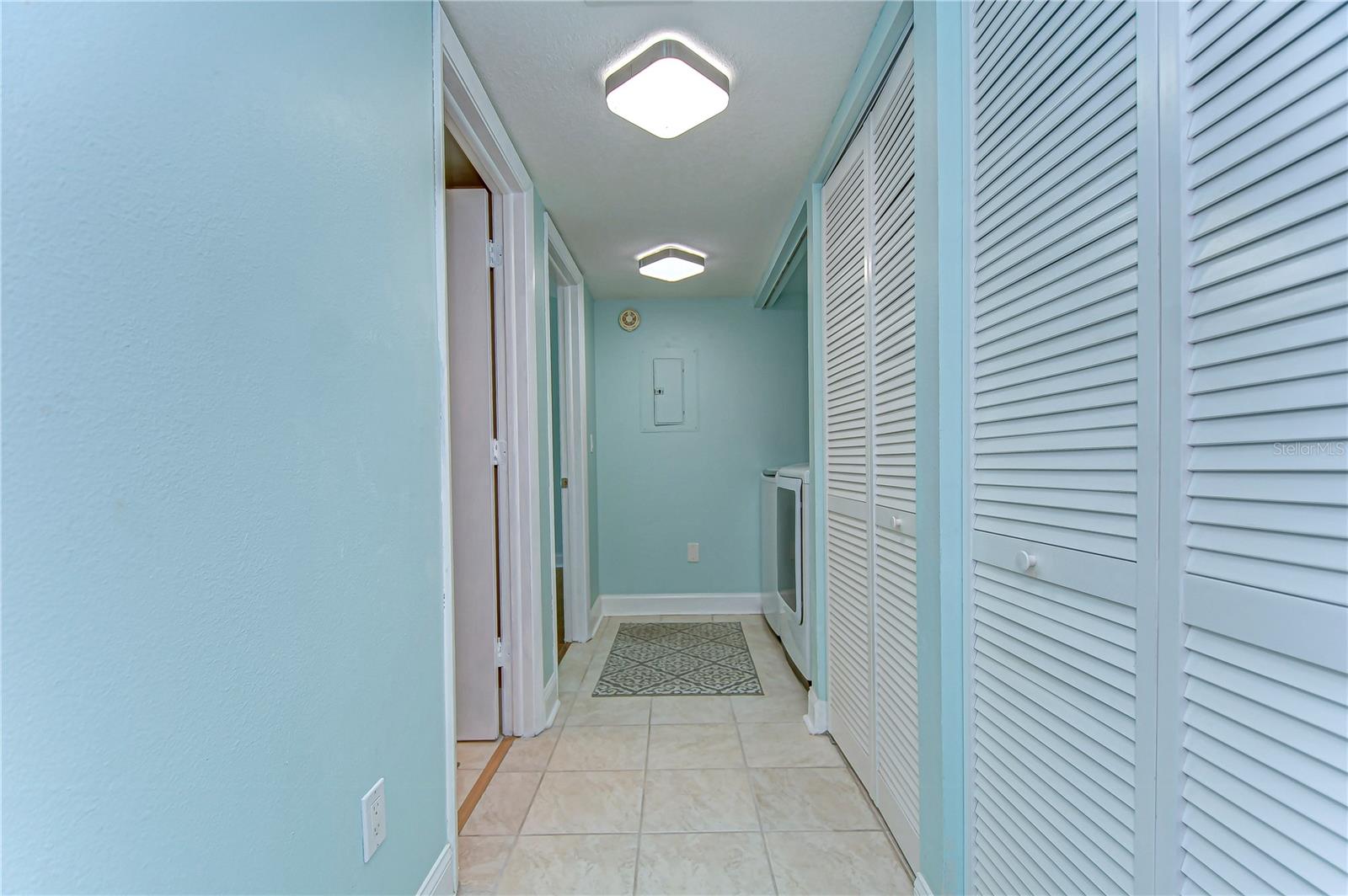 The beautiful hallway leading to the bed and bathroom is flanked by storage closets!