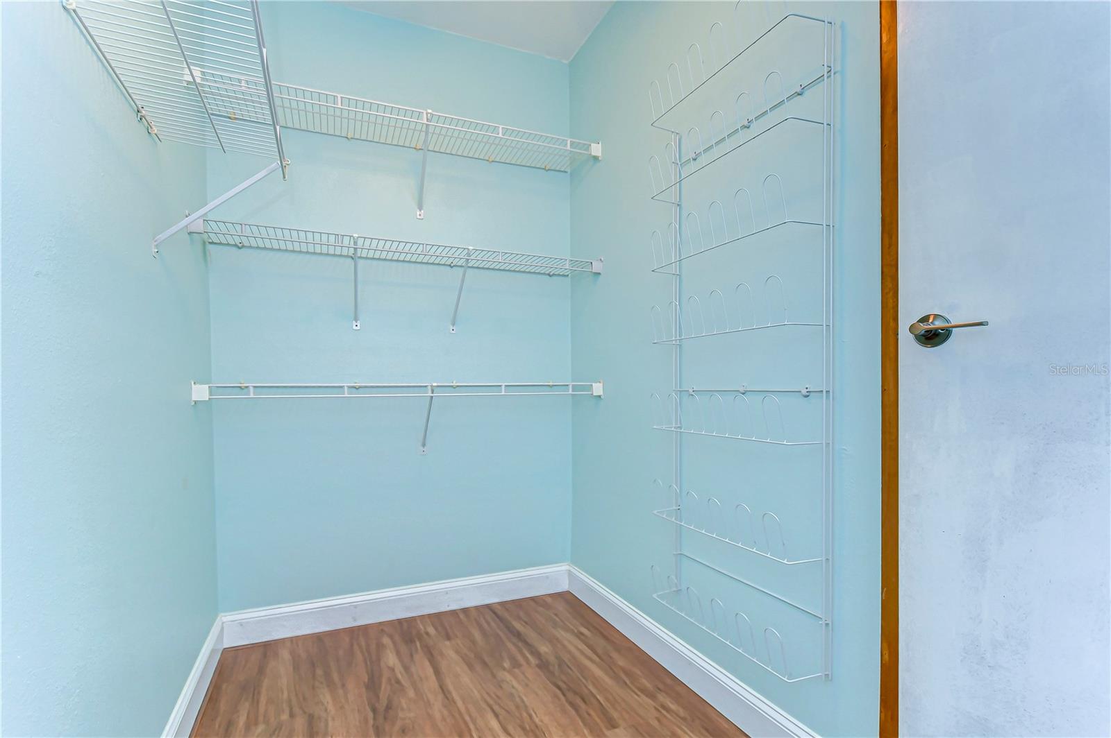 Step into a wardrobe oasis with this spacious and organized walk-in closet.