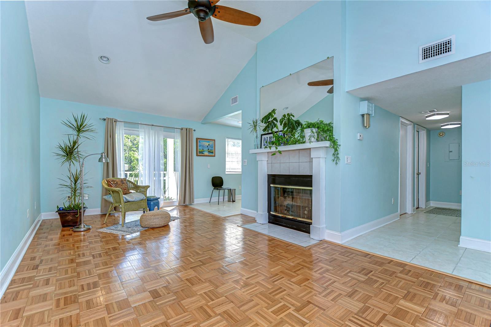 This charming living space, nestled under soothing cathedral ceilings, invites you to enjoy the view from generous windows.