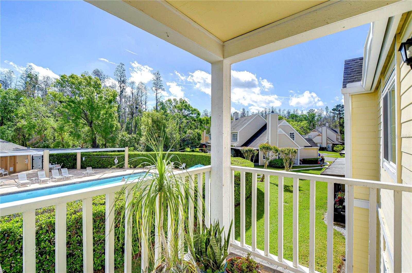 Overlooking the lush greenery and inviting pool area, this charming hideaway provides tranquility and comfort.