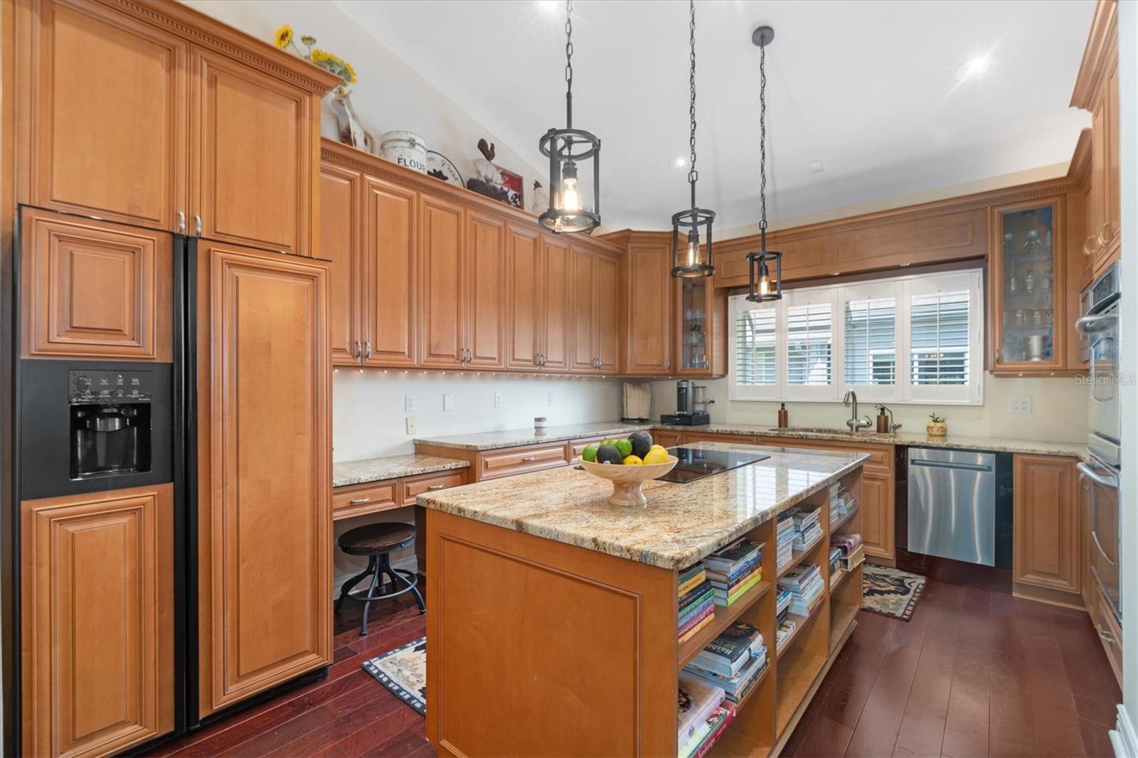 Granite Countertops, Raised Panel Maple Cabinets, and Custom Maple Wood Paneled Refrigerator