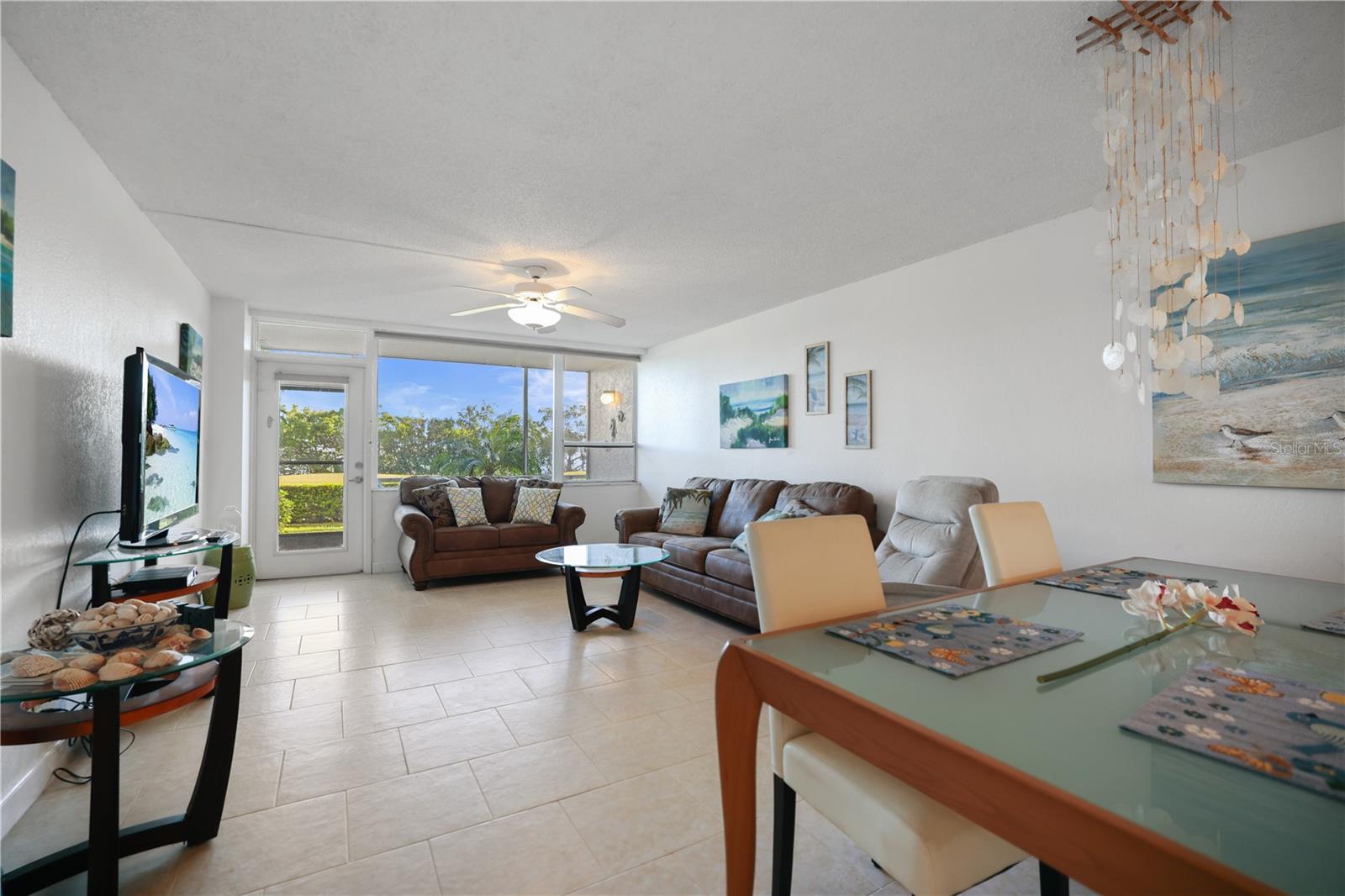 Living room Dining room combo - looking toward the screened porch in back with its views of the golf course and Tampa Bay.