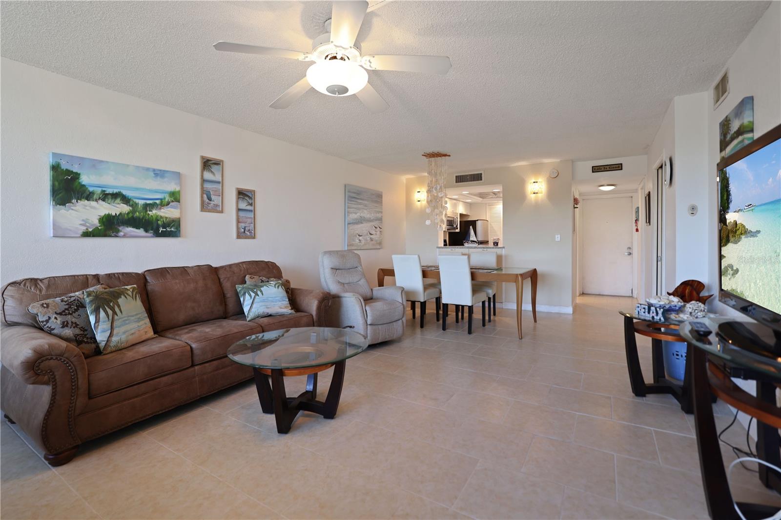 From the back of the condo toward the front, across the living room dining room combo.