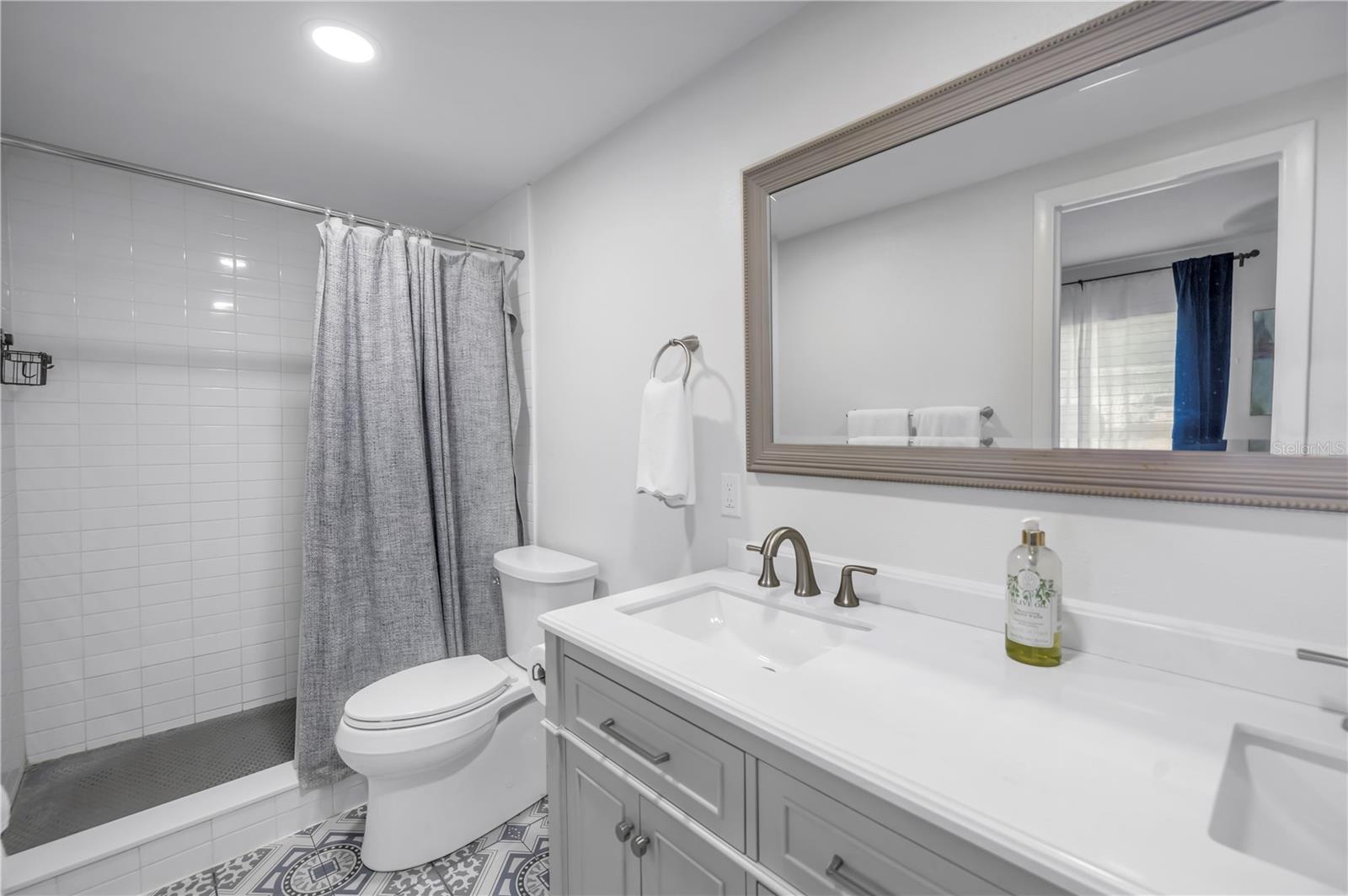 Main bathroom with double sinks and walk in shower