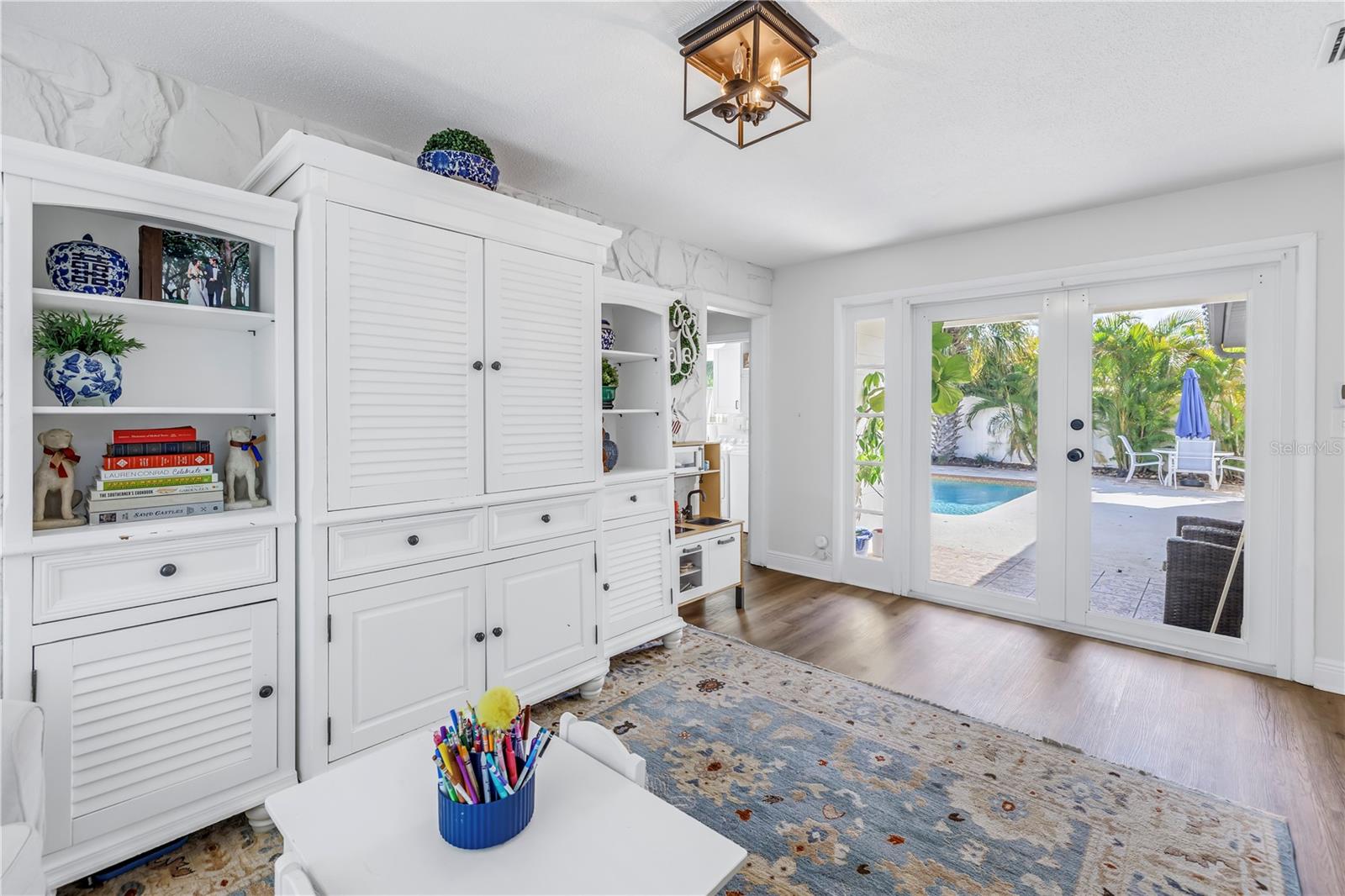 from the den double doors take you to the covered patio and pool