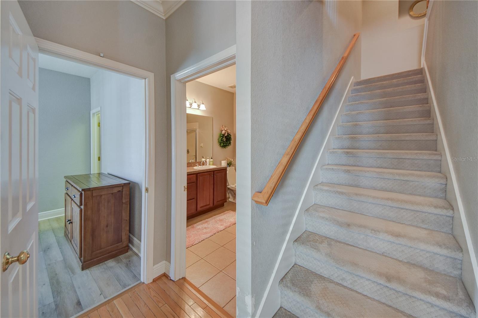 Staircase off entryway heading to 2nd floor landing