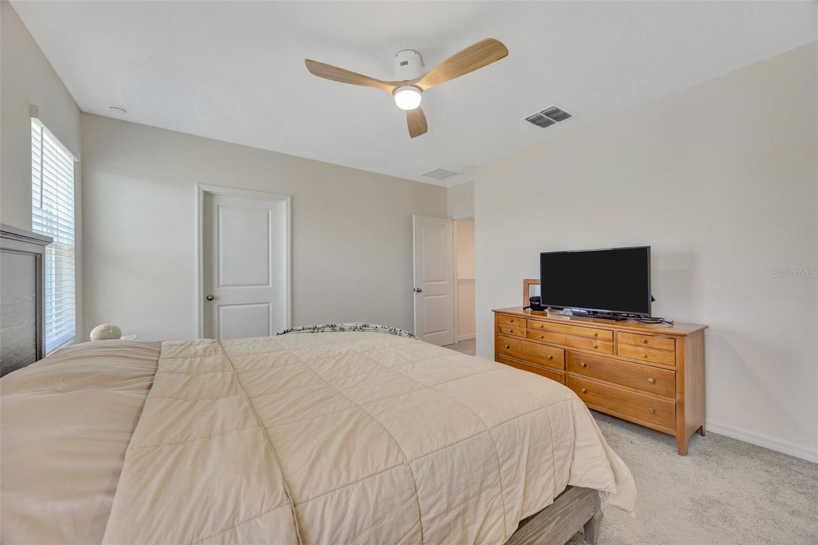 Primary bedroom with oversized walk in closet and en suite bathroom