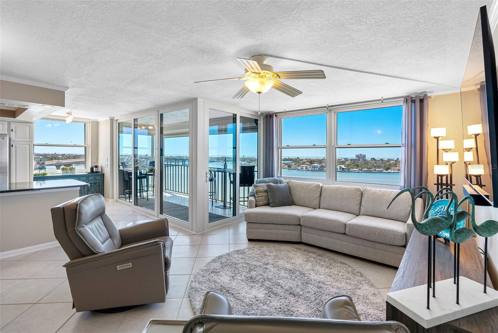 Floor-to-ceiling windows flood the living space with natural light and stunning 180-degree water views.