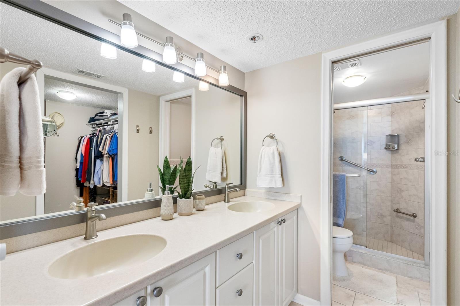 Elegant dual vanities and a marble/glass shower complete this spa-like ensuite.