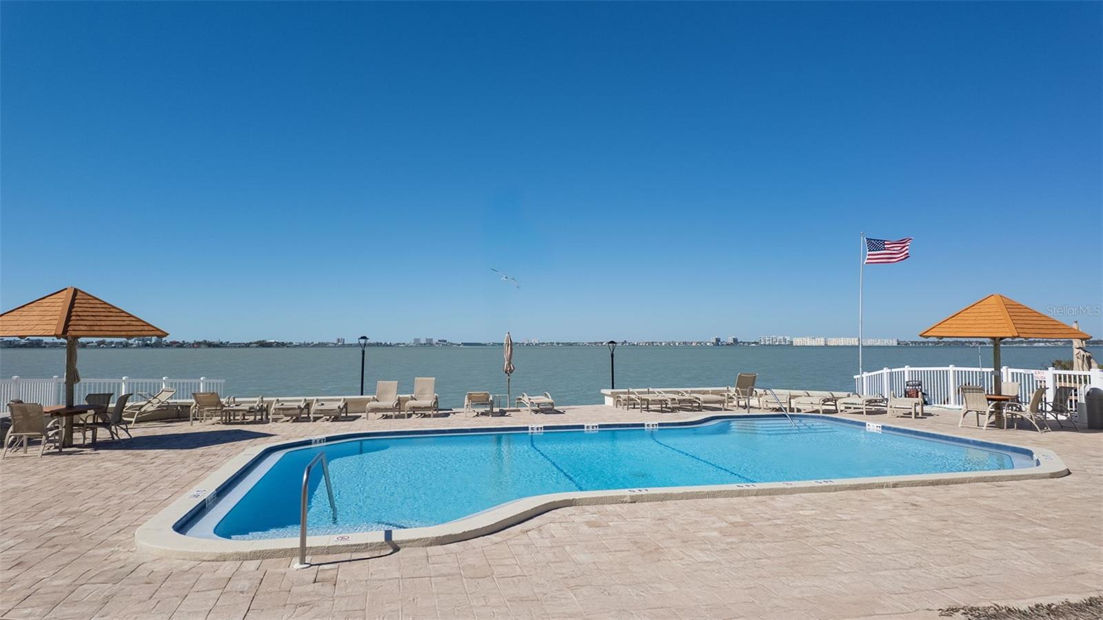 Heated waterfront pool and spa — relax with water views from every angle.