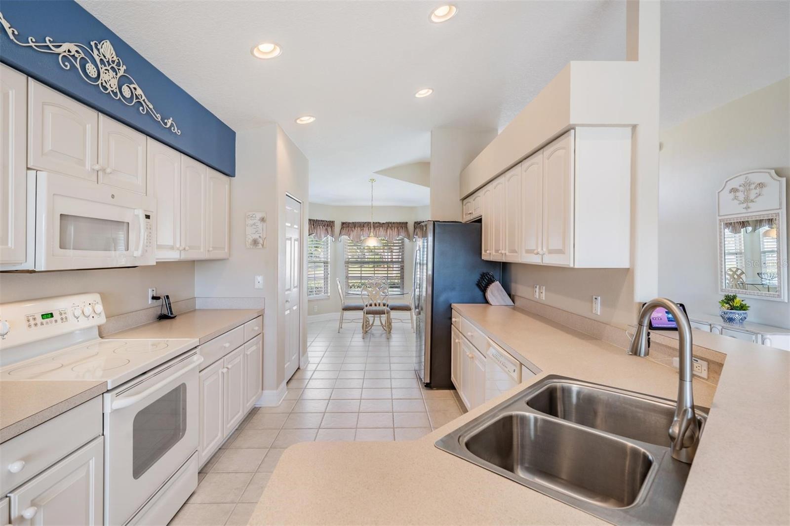 The white appliances blend in well with the cabinets