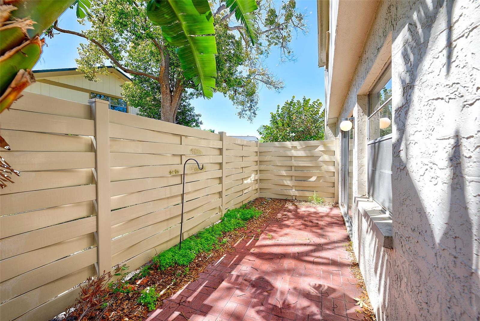 Fenced wrap-around patio