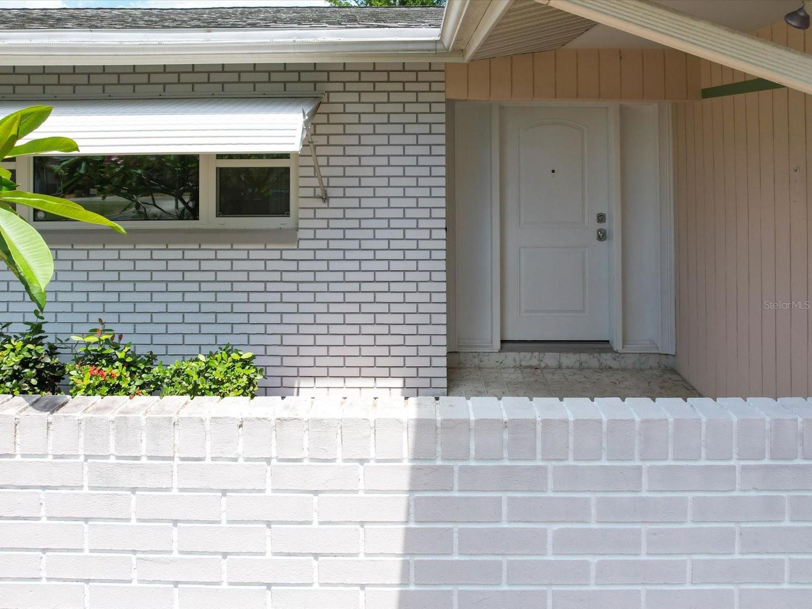 Entrance behind block wall
