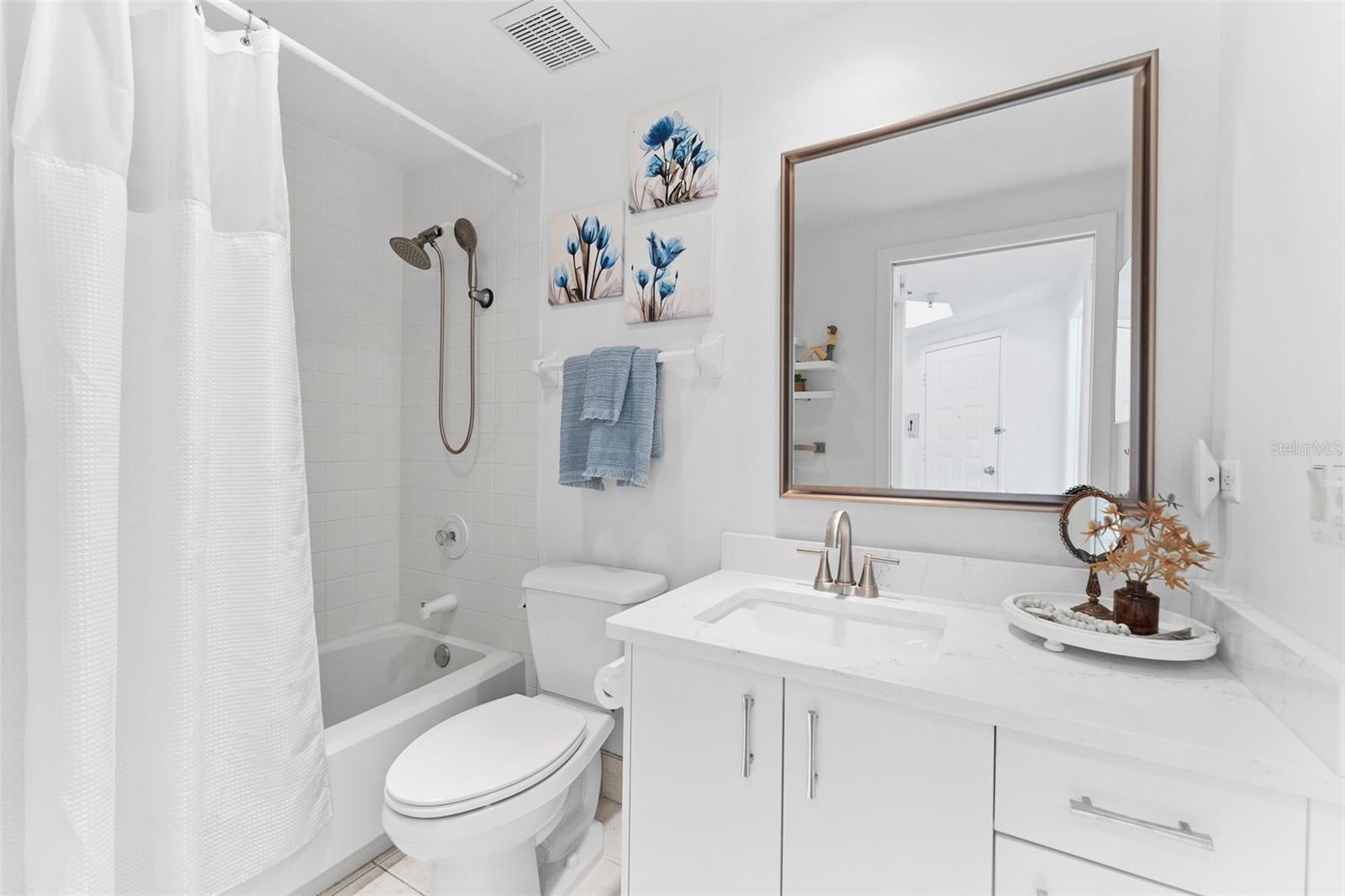 The hall/ guest bathroom has been refreshed with new countertops and accessories