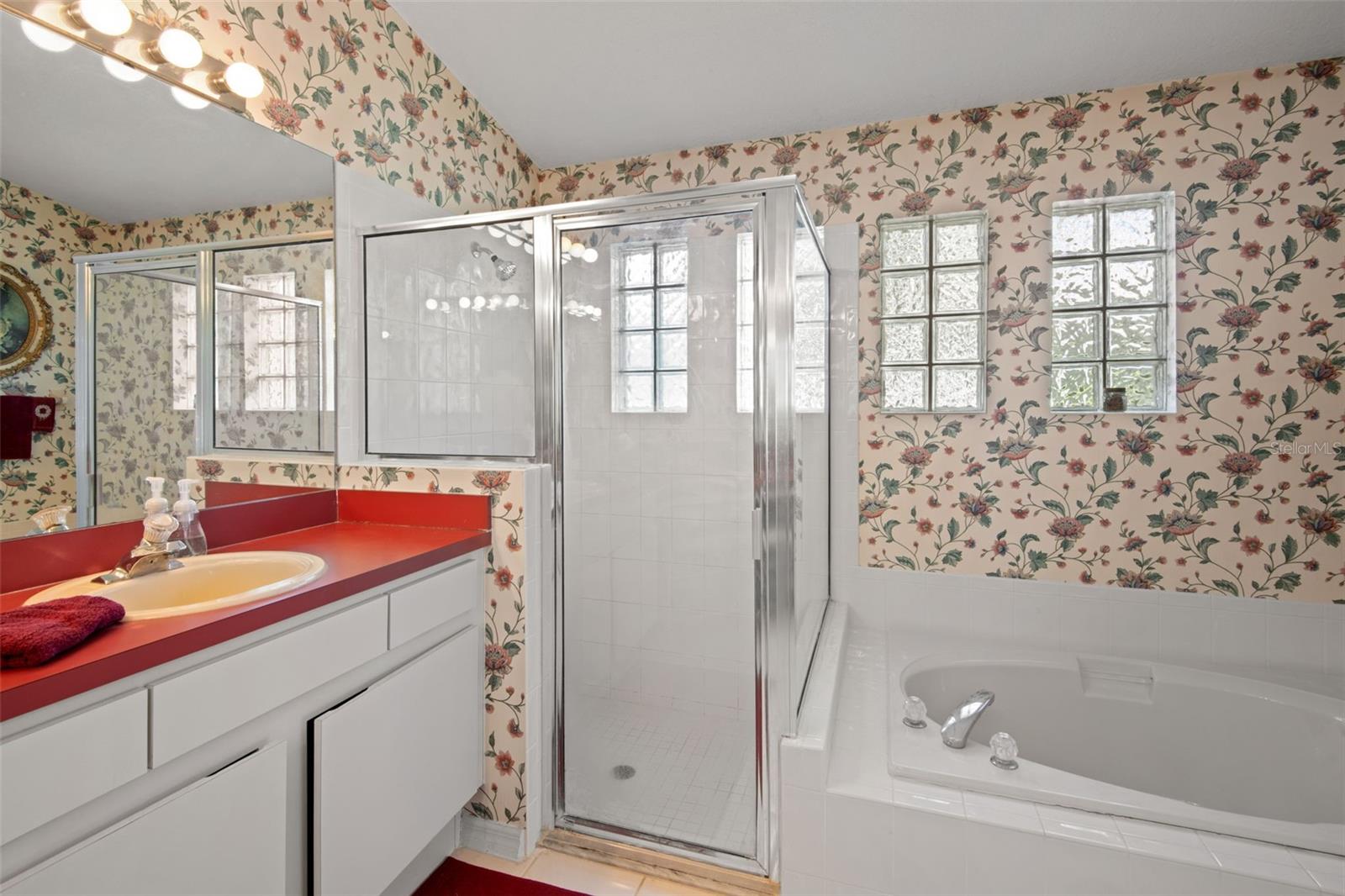 En-suite main bathroom with separate shower and tub