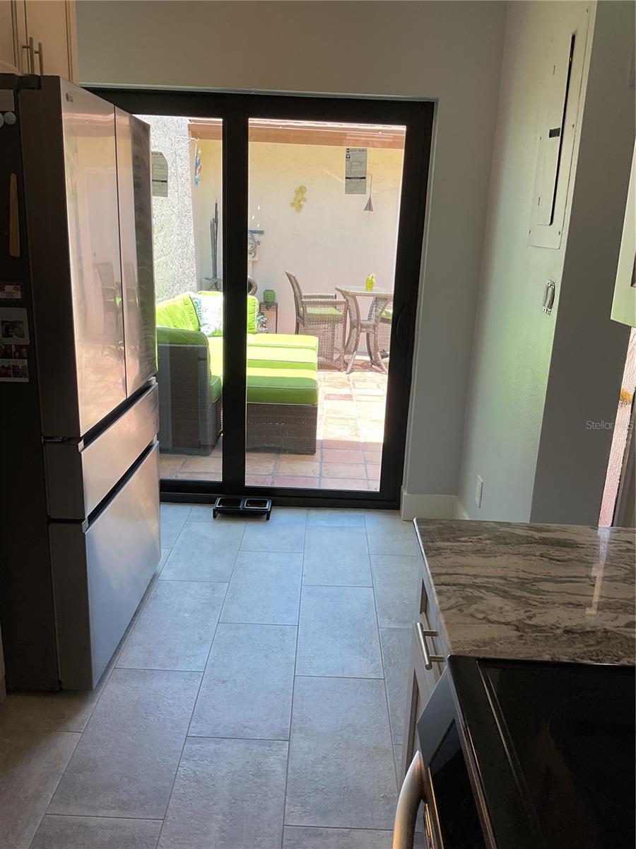 KITCHEN WITH VIEW OF NEW SLIDER OUT TO THE COURTYARD