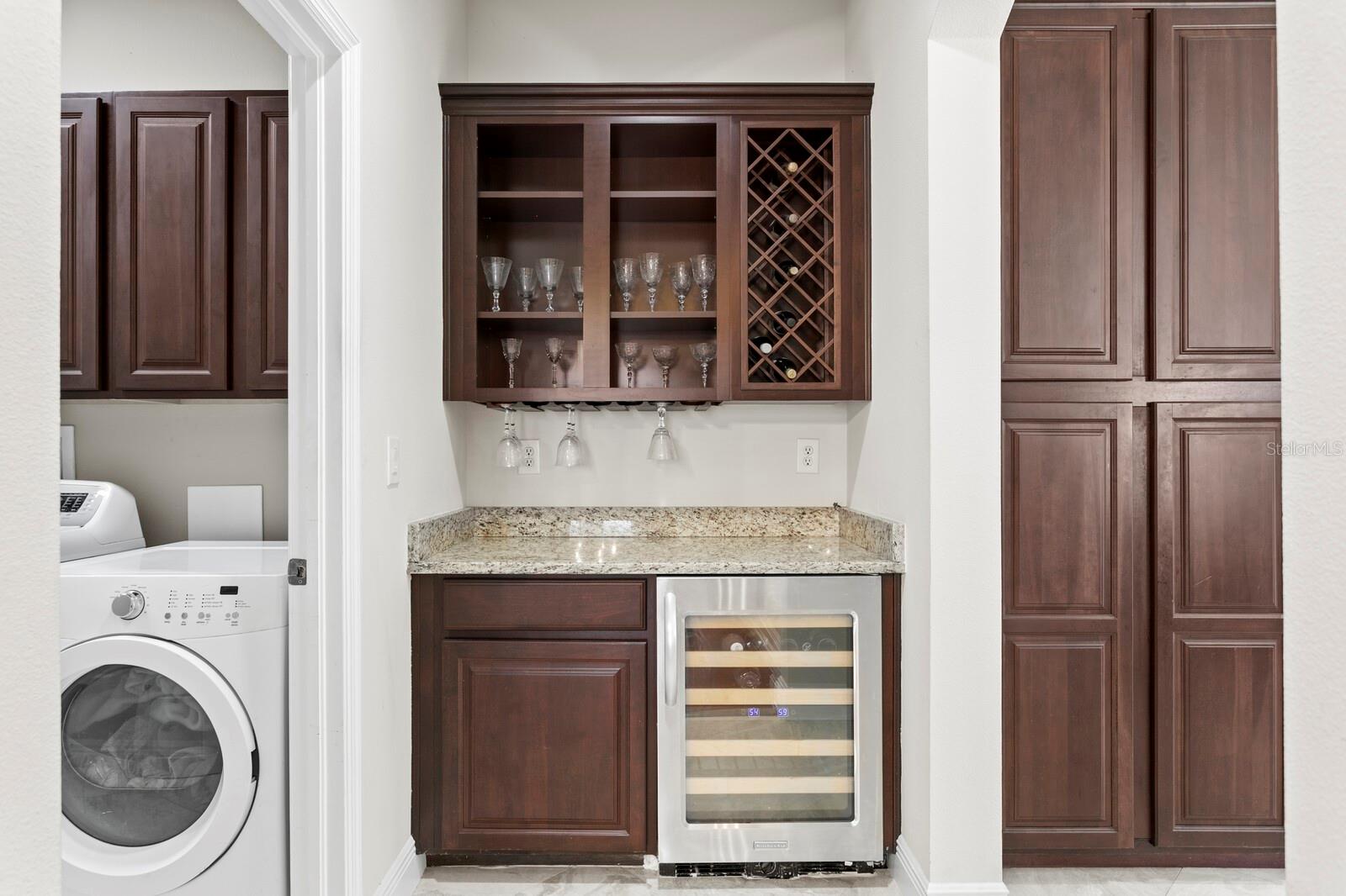 Just off the kitchen is the butler pantry and wine serving station