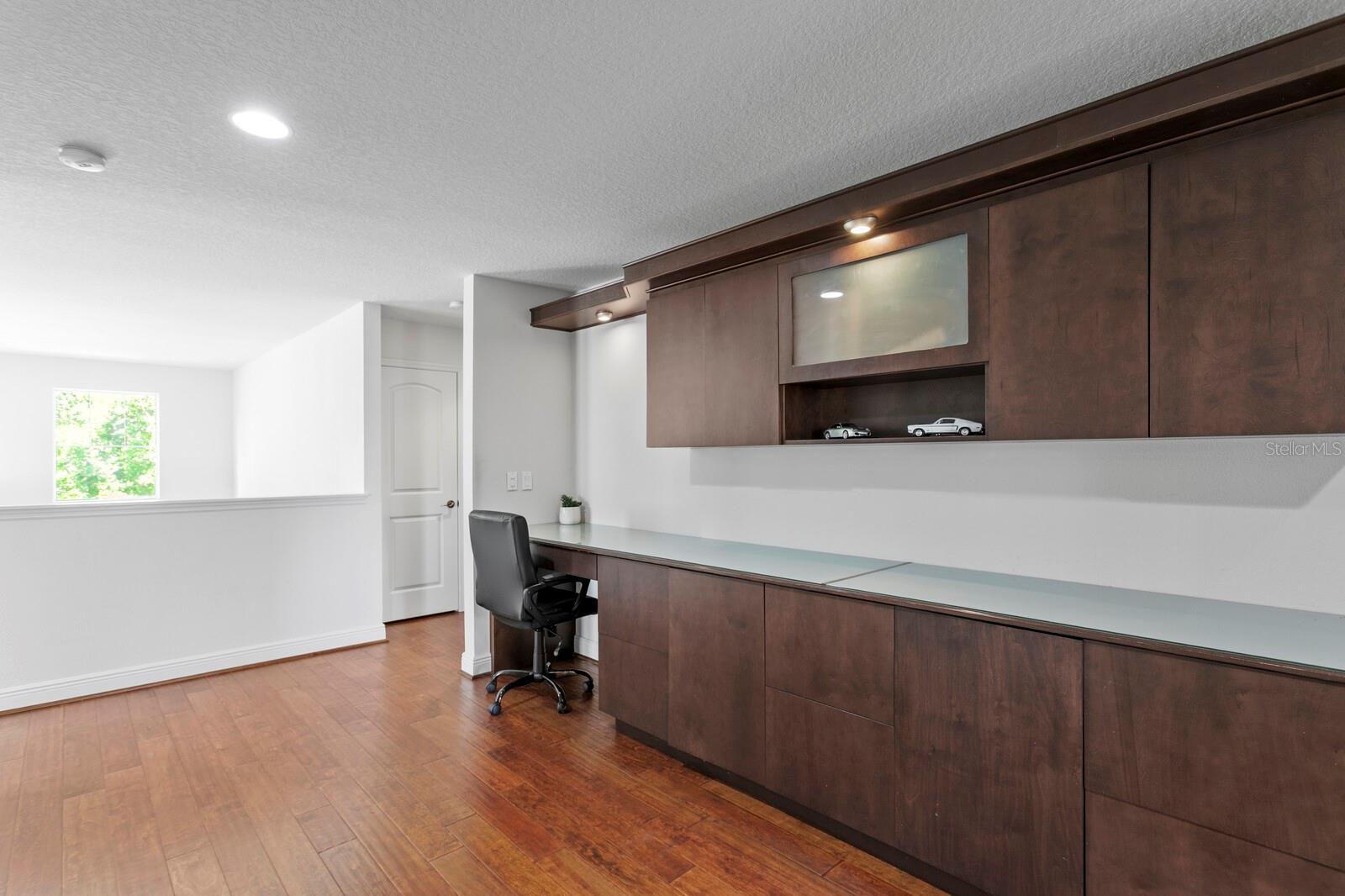 The bonus room features custom built-in workstations